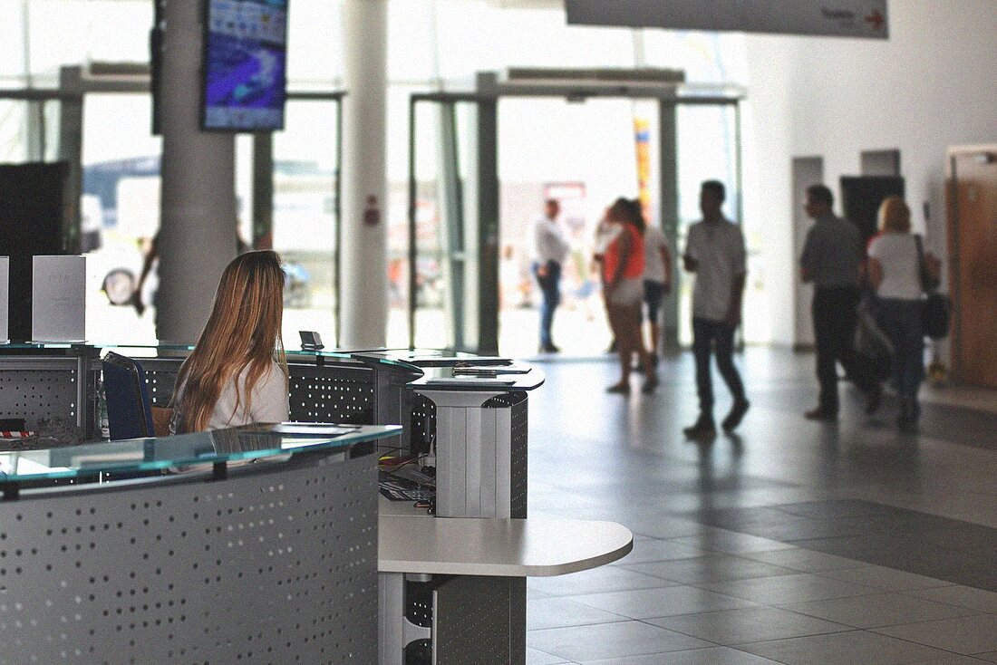 Front desk security officer checking visitor credentials in an Orlando office lobby