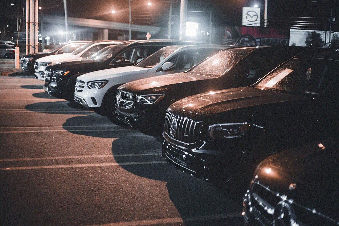 Security officer patrolling a car dealership lot in Orlando at night