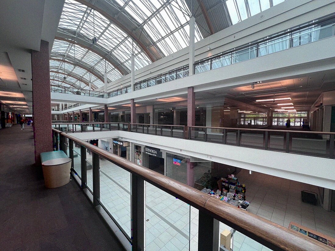 Empty shopping center walkway in Orlando under a skylight after hours